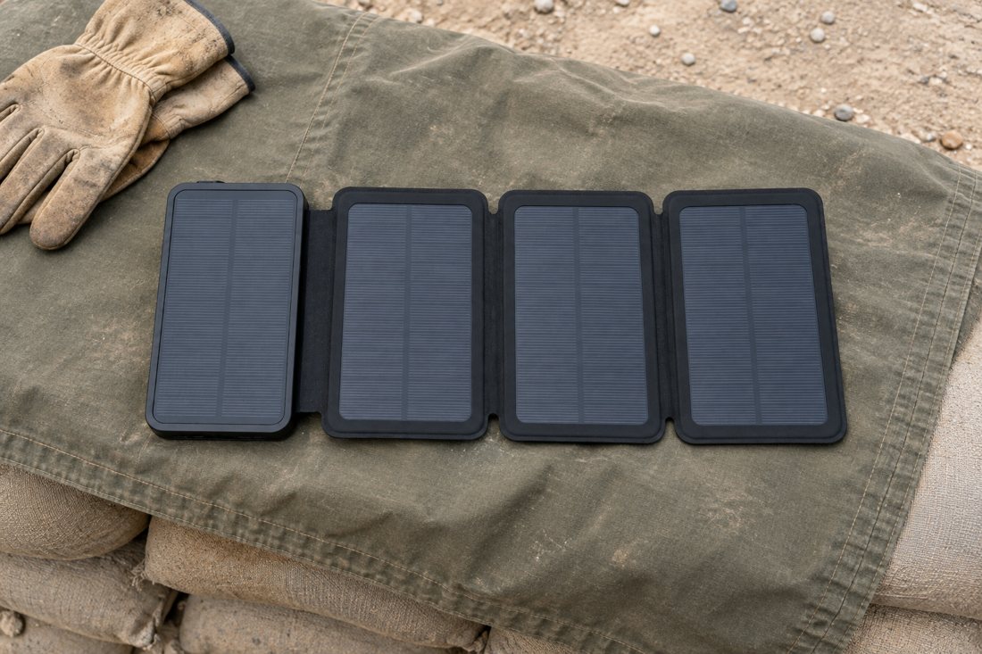 SPEC-G: open unit on an olive tarp over sandbags with work gloves